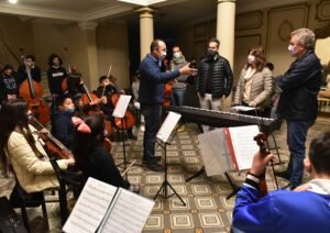 La Orquesta Escuela Infantil y Juvenil Barrio Miramar realizó un ensayo en el Teatro Municipal con presencia del intendente Gay. El grupo adoptó una nueva identidad visual y recibió un piano eléctrico donado por la Municipalidad para fortalecer su formación musical en niños y adolescentes.